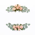 Frame made of pink roses, green leaves eucalyptus, branches, floral pattern on white background. Flat lay, top view Royalty Free Stock Photo