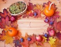 Frame made of pumpkins, autumn leaves and fresh fruits on wooden background Royalty Free Stock Photo