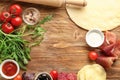 Frame made with raw dough and ingredients for pizza on table Royalty Free Stock Photo