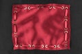 Frame made of red silk with inserted red satin ribbon, on black silk background. Royalty Free Stock Photo