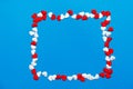 Frame made of red and white hearts on blue background Royalty Free Stock Photo