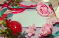 Frame made of ribbons and flowers on a white background with copy space