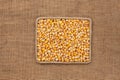 Frame made of rope with corn grains on sackcloth, view from above Royalty Free Stock Photo