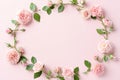 Frame made of rose flowers, petals and heart shaped confetti on light pink background. Floral composition Royalty Free Stock Photo