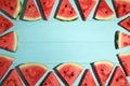 Frame made with slices of ripe watermelon on light blue wooden table, flat lay. Space for text Royalty Free Stock Photo