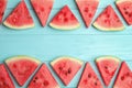 Frame made with slices of ripe watermelon on light blue wooden table, flat lay. Space for text Royalty Free Stock Photo