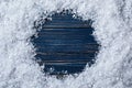 Frame made of snow on blue wooden background, top view. Christmas time Royalty Free Stock Photo