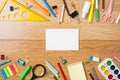 Frame made of stationery and blank paper card in the center, school supplies on wooden table. Education, studying and back to Royalty Free Stock Photo