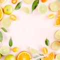 Frame made of summer tropical fruits: orange, lemon, lime, mango on pink background. Food concept. flat lay, top view Royalty Free Stock Photo