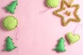 frame made of toys on a pink background. felt ornaments in the form of balls, hearts and fir-trees.