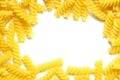 A Frame Made from Uncooked Fusilli Pasta Scattered on White Table - Mock Up. Royalty Free Stock Photo