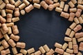 Frame made of wine bottle corks on black table, flat lay. Space for text Royalty Free Stock Photo
