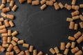 Frame made of wine bottle corks on black table, flat lay. Space for text Royalty Free Stock Photo