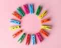 Frame of many different colorful clothes pins on pink background, flat lay. Diversity concept Royalty Free Stock Photo