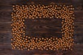 Frame of many hazelnuts with shells on brown wooden boards Royalty Free Stock Photo