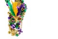 Frame of Mardi Gras mask and beads isolated on white background. Royalty Free Stock Photo