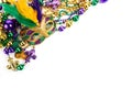 Frame of Mardi Gras mask and beads isolated on white background. Royalty Free Stock Photo