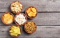 Frame Mix of snacks : pretzels , crackers , chips nachos and pop corn