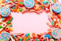 Frame from mixed collection of colorful candy, on pink background. Flat lay, top view Royalty Free Stock Photo