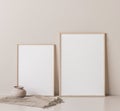 Frame mock up in empty room on beige wall, two wooden frames standing on white floor