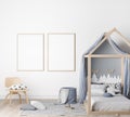 Frame mock up in kids bedroom, modern blue bed in bright interior, tow wooden frames on white wall background Royalty Free Stock Photo