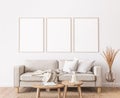 Frame mockup in farmhouse living room design, white furniture on bright wall background Royalty Free Stock Photo