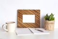 Frame mockup, houseplant, cup of coffee and notebook Royalty Free Stock Photo