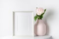 Frame mockup with pink peony flowers in vase, mockup for artwork presentation