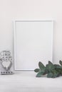 Frame mockup, vintage candle holder, branches of green eucalyptus on white background