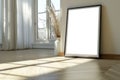 Frame mockup white picture on wood floor against wall, detail of modern minimalist room interior with blank poster and window. Royalty Free Stock Photo
