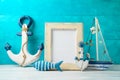 Frame and nautical summer decorations on wooden table