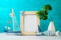 Frame and nautical summer decorations on wooden table