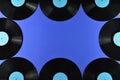 Frame of old black vinyl records on blue background Royalty Free Stock Photo