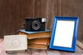 Frame with old books and old camera on wood table Royalty Free Stock Photo