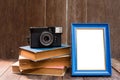 Frame with old books and old camera on wood table Royalty Free Stock Photo