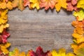 Frame out of colourful autumn leaves on wooden background Royalty Free Stock Photo