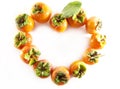 Frame. Persimmon with a leaf, heart on a white background. Ripe fruit. Color photo