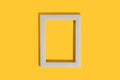 Frame for photo or painting on bright yellow background. Mockup. Place to insert text, images. Top view. Flat lay.