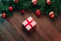 A frame of pine branches and Christmas decorations and gifts on a wooden table. Holidays christmas background. View from above Royalty Free Stock Photo