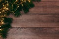 Frame from the pine branches and Christmas decorations on an old wooden table. Holidays Christmas background. Space for text or Royalty Free Stock Photo