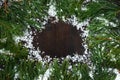 Frame of pine branches with long needles on the background of a dark wooden table Royalty Free Stock Photo