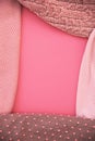 Frame of pink sweaters with copy space for text, womanly accessories, warm clothing for autumn or winter