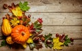 Frame. Pumpkins, maple leaves and chestnuts on a wooden background. Congratulation Royalty Free Stock Photo