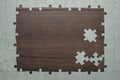 Frame of puzzle pieces on wooden background Royalty Free Stock Photo