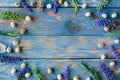 Frame of quail eggs and sage flowers on a worn blue wooden table. Flat layout with copy space Royalty Free Stock Photo