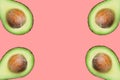 Frame from raw ripe halved avocados with pit isolated on pink background. Creative food poster