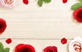 The frame of red and pink roses and rose petals with a wooden table background Royalty Free Stock Photo