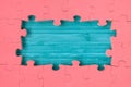 The frame from red puzzle on blue wooden background Royalty Free Stock Photo