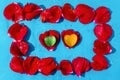Frame of red rose petals on blue background. Two gem stone heart on rose petals in the middle. Abstract love and romance concept Royalty Free Stock Photo