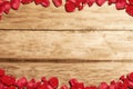 The frame of red rose petals with a wooden table background Royalty Free Stock Photo